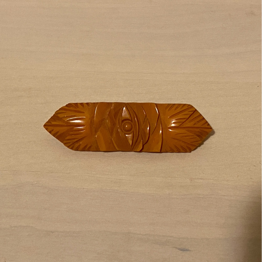 Vintage Orange Bakelite Brooch with carved floral design 
c. 1940s
